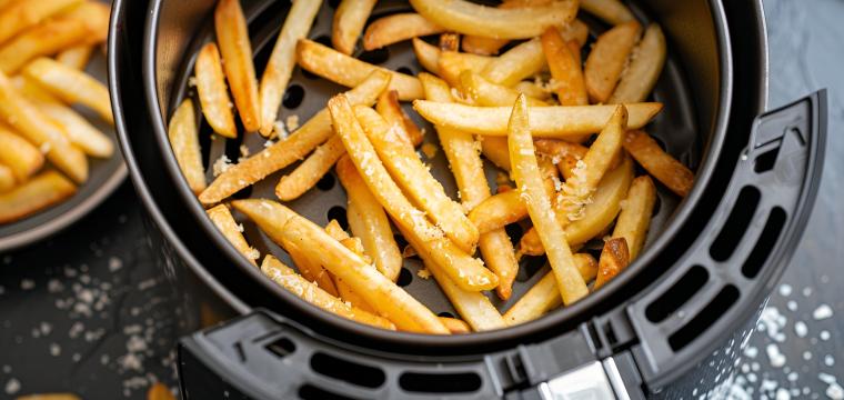 Selbstgemachte Pommes in der Schublade einer Heißluftfritteuse Selbstgemachte Pommes in der Schublade einer Heißluftfritteuse